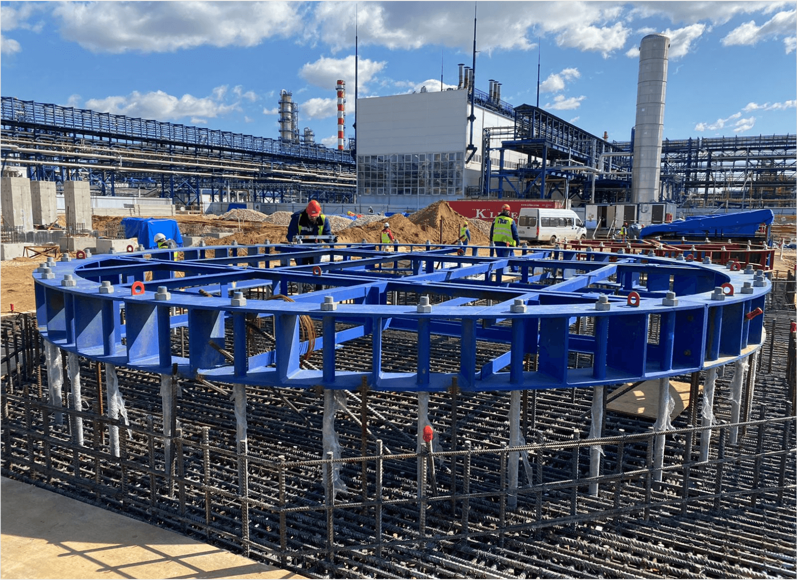 blue construction facility with two builders behind